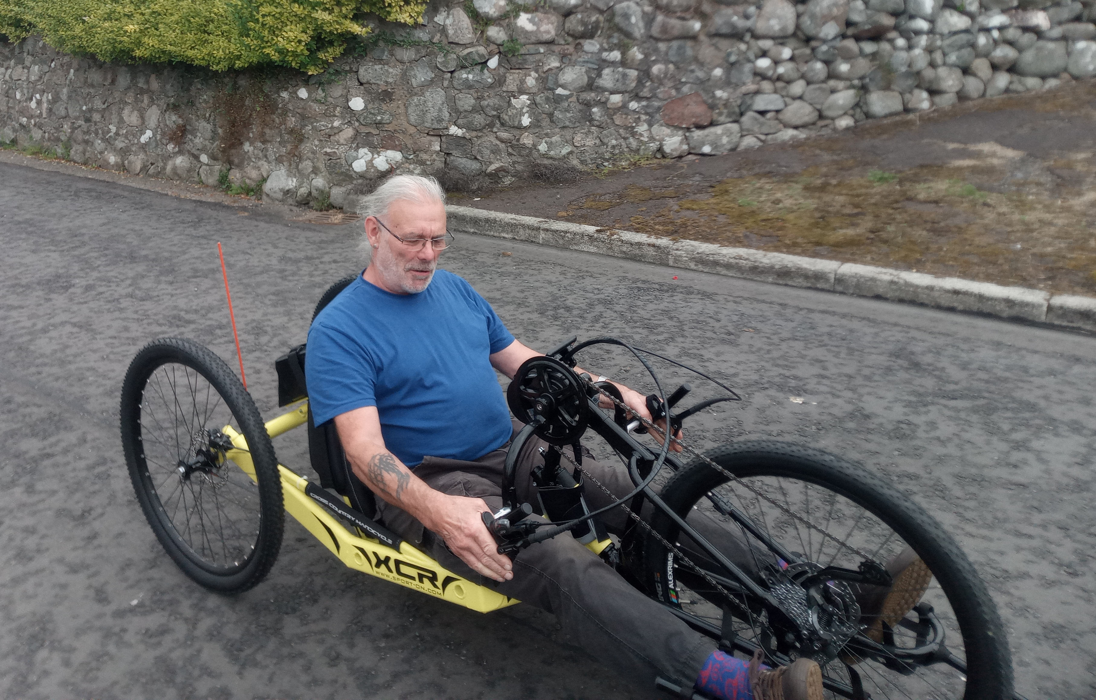 Our new hand cycle, being ridden up Main Street
